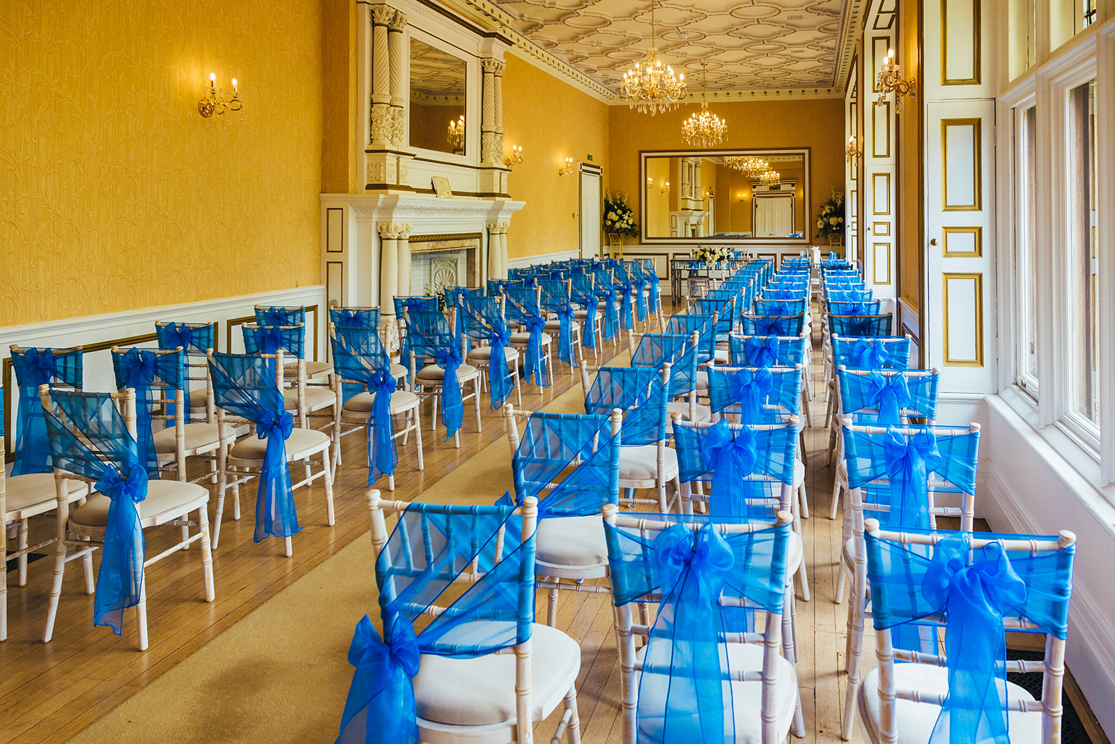 Photo by Kirsty Rockett Photography, of Holmewood Hall's beautiful main ceremony room decked out with the blue sashes we requested.